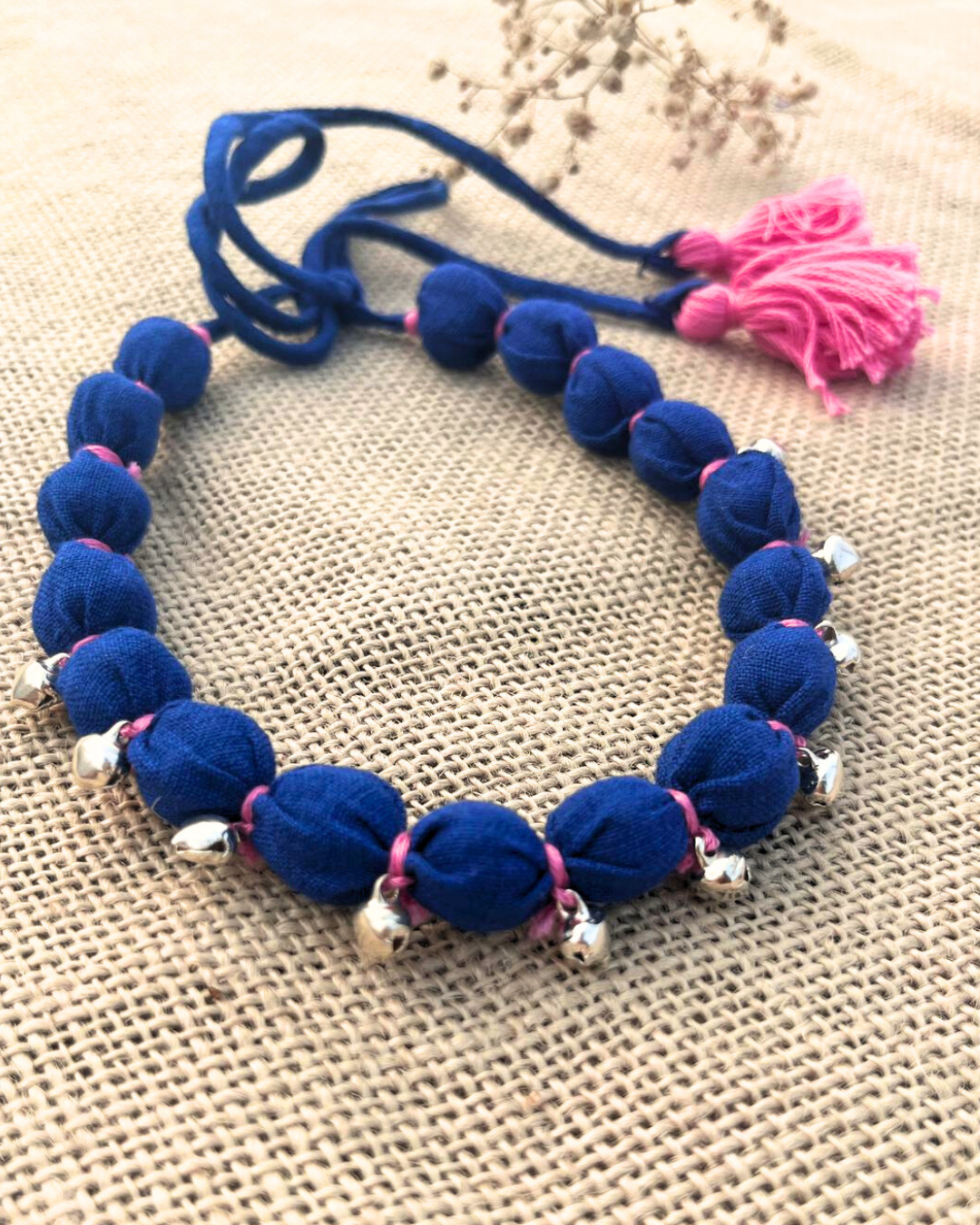Blue beaded necklace with pink accents 