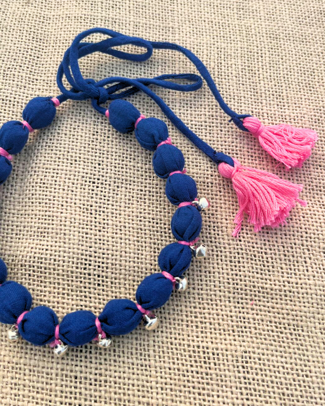Blue beaded necklace with pink accents 