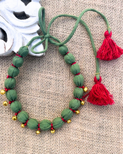 Green beaded necklace with red tassels 