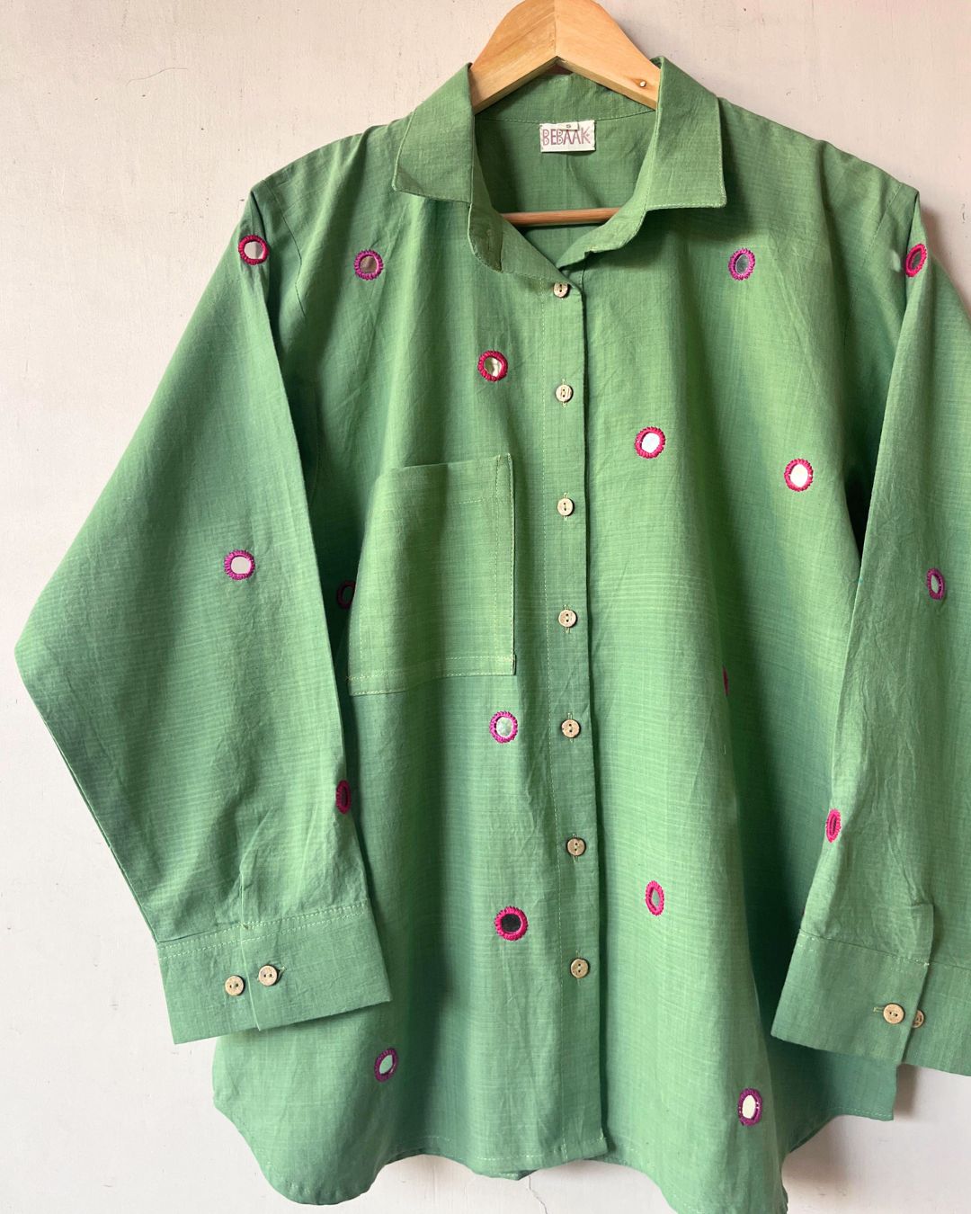 Green shirt with pink mirror work
