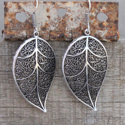 Earrings: Leaf shape danglers silver in color