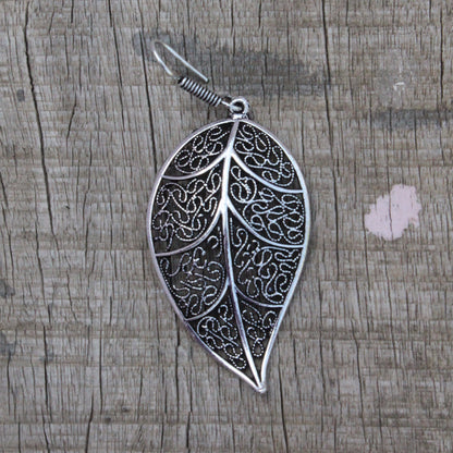 Earrings: Leaf shape danglers silver in color